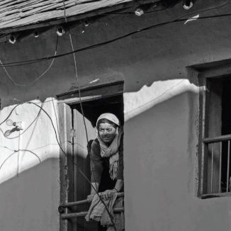 a woman in a village near a resort in dharmshala