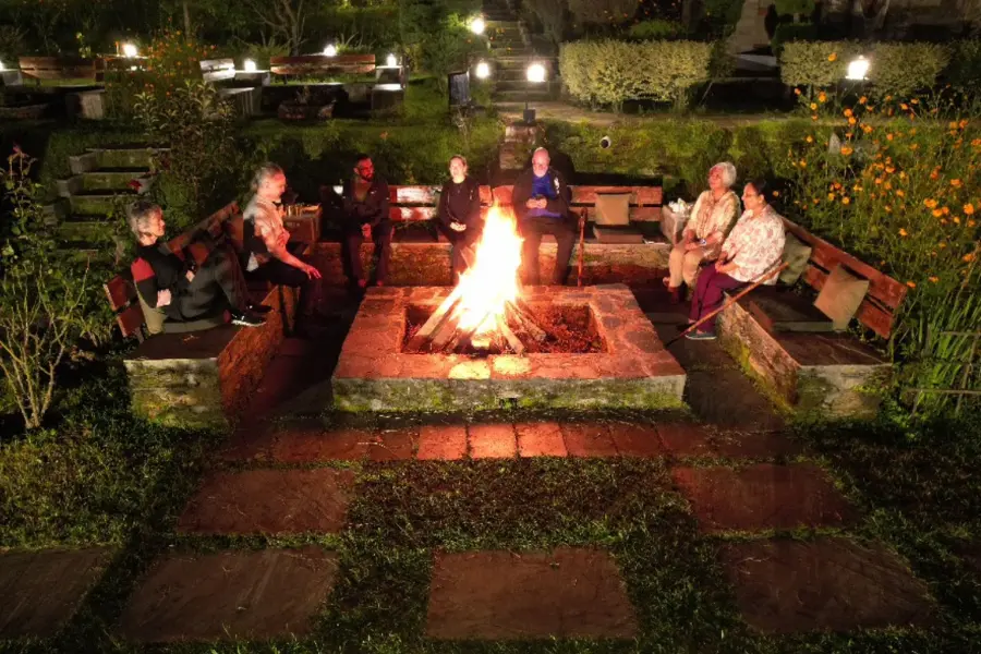 Guests enjoying a cozy winter bonfire evening at Rakkh Resort near Dharamshala
