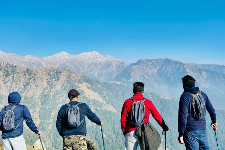 group of adventures enjoying the view from top of the hill