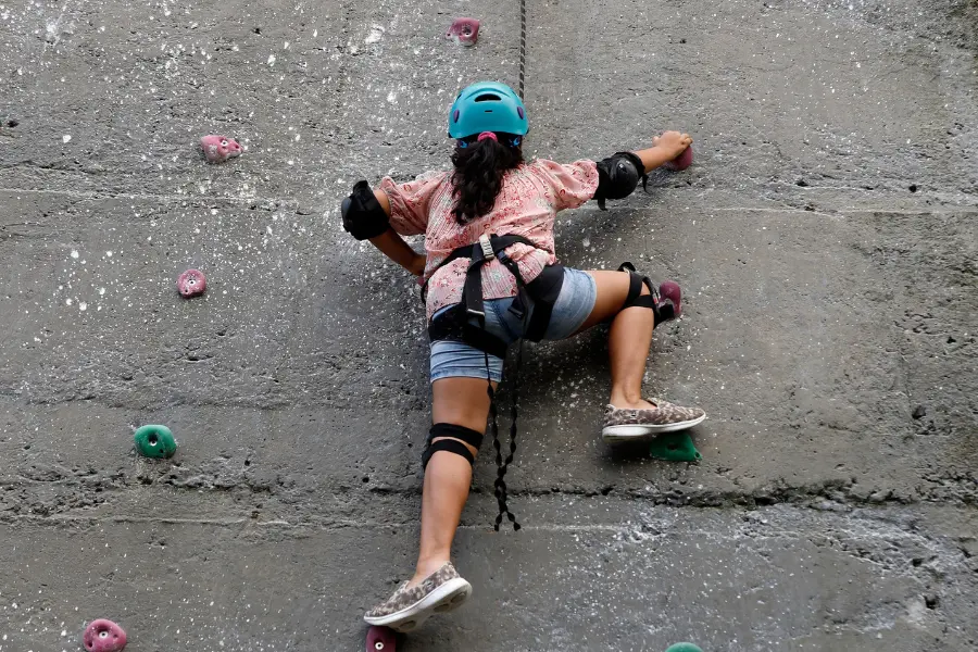 View of guest enjoying a rock climbing activity at Rakkh Resort’s adventure wall.