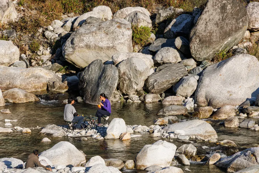 View of guests at a riverside picnic.